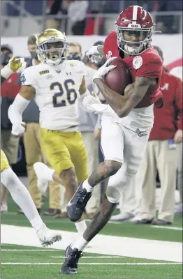  ?? THE ASSOCIATED PRESS FILE – 2021 ?? Heisman Trophy-winning wide receiver DeVonta Smith, right, had 117 receptions for 1,856 yards and 23 touchdowns for national champion Alabama last season.