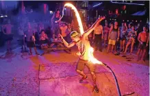  ??  ?? A partygoer getting caught by a fiery skipping rope during a Full Moon Party.