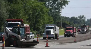  ?? ERIC BONZAR—THE MORNING JOURNAL ?? Crews work to strip the surface of roadway on U.S. Route 6, near Mercy Hospital, July 19, 2017. The Ohio Department of Transporta­tion’s $3.3 million project, awarded to Chagrin Valley Paving Inc. of Chagrin Falls, will repave nine miles of Route 6...