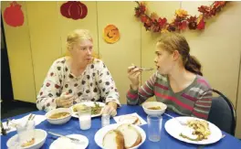  ?? — AP photos ?? PORTLAND: Vicki McMahon (left) and her daughter, Cheyennee McMahon-Dumont, dine on venison shepherd’s pie at a church dinner in Portland, Maine.