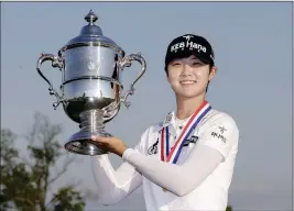  ?? ASSOCIATED PRESS ?? SOUTH KOREA’S SUNG HYUN PARK holds up the championsh­ip trophy after winning the U.S. Women’s Open golf tournament Sunday in Bedminster, N.J.