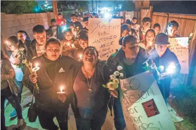  ?? PHOTOS BY MICHAEL CHOW/THE REPUBLIC ?? Sandra Gonzalez, center, cries out while marching Wednesday evening with other mourners during a candleligh­t vigil for her son, Antonio Arce, in an alley in Tempe. A year ago a Tempe police officer shot and killed the 14-year-old while he fled with an air soft gun.