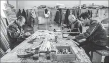  ?? PHOTOS BY XIAO SONG / CHINA DAILY ?? Top: Chen Genquan, a cultural relics repairer, is engaged in some woodwork in Qufu, East China’s Shandong province. Above: Chen (left) and his colleagues work to restore ancient wooden structures and artifacts for the Confucius Temple.