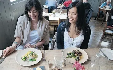  ?? For the Calgary Herald ?? American food blogger Carolyn Cope, left, and Calgary chef Roxane Shymkiw prepare to enjoy their lunch at London’s Michelin-starred pub, The Harwood Arms.