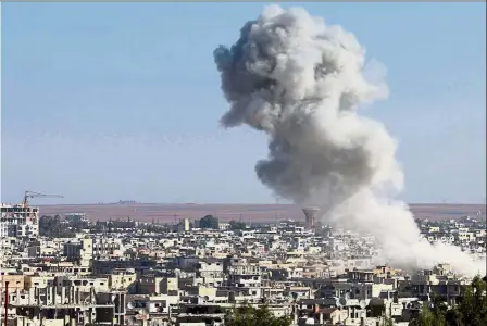  ??  ?? Under attack: Smoke billows following an air strike by Syrian government forces in the rebel-held area of Daraa, in southern Syria. — AFP