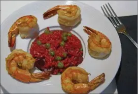  ?? PHOTO BY EMILY RYAN - FOR MEDIANEWS GROUP ?? General Warren serves beet risotto with sweet peas and shrimp.