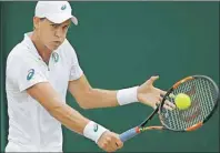  ?? AP PHOTO ?? Canadian Vasek Pospisil returns a shots Monday at Wimbledon.