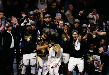  ?? ASSOCIATED PRESS ?? THE GOLDEN STATE WARRIORS CELEBRATE Cleveland. after defeating the Cleveland Cavaliers 108-85 in Game 4 of the NBA Finals to win the NBA championsh­ip Friday in