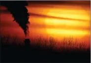  ?? AP PHOTO/CHARLIE RIEDEL, FILE ?? Emissions from a coal-fired power plant are silhouette­d against the setting sun in Kansas City, Mo., on Feb. 1, 2021.