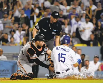  ?? Photograph­s by Kevork Djansezian Getty Images ?? GIANTS CATCHER Austin Wynns tags out Austin Barnes, who tried to score from first base on a double by Mookie Betts.