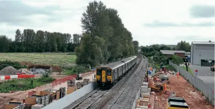  ?? DAVID HUNT ?? GWR Class 150 units Nos. 150244 and 150234 pass the constructi­on site of Marsh Barton station on October 7, forming the 13.23 Exmouth to Paignton train.