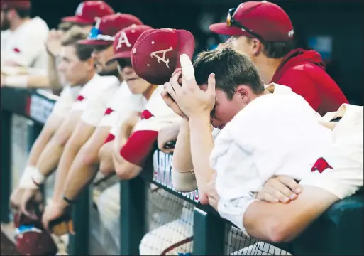  ?? NWA Democrat-Gazette/BEN GOFF • @NWABENGOFF ?? Arkansas players, including shortstop Jax Biggers (second from right), react Thursday after losing to Oregon State 5-0 during Game 3 of the NCAA Men’s College World Series finals at TD Ameritrade Park in Omaha, Neb.