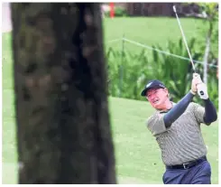  ??  ?? Legend at work: Ernie Els of South Africa blasting the ball from the rough at the 11th hole during the first round yesterday.