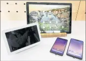  ?? RICHARD DREW — THE ASSOCIATED PRESS ?? The Google Home Hub, left, Pixel Slate, center, and two new smartphone­s are displayed. Google’s new Pixel phones mirror the industry trend moving toward bigger screens.