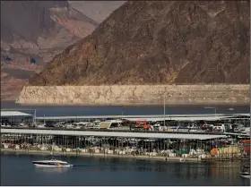  ?? (AP/John Locher) ?? A ring of light minerals delineates the high-water mark on Lake Mead at the Lake Mead National Recreation Area near Boulder City, Nev.