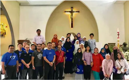  ??  ?? In the spirit of harmony: Shah Kirit (front row, fourth from left) and other Global Unity Network members with the St Joseph Church congregati­on in Sentul, Kuala Lumpur.