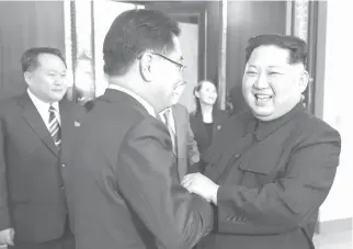  ?? AFP PHOTO/KCNA VIA KNS ?? WARM WELCOME
This picture released by North Korea’s Korean Central News Agency (KCNA) on Tuesday shows North Korean leader Kim Jong-Un (right) shaking hands with South Korean chief delegator Chung Eui-yong (center), who traveled as envoys of the...