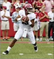  ?? ASSOCIATED PRESS FILE ?? Alabama quarterbac­k Tua Tagovailoa rolls out before throwing a touchdown pass against Arkansas in the first half in Fayettevil­le, Ark.