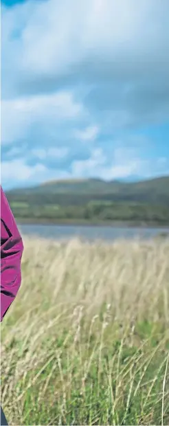  ?? ?? Author Graham Morgan takes a walk in fields near his Cardross home, and right, in his youth, years before diagnosis
Picture Andrew Cawley