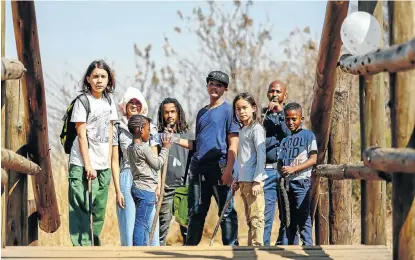  ?? Picture: Moeletsi Mabe ?? Unschooler­s Kaspar Reineke, Ana Michela de Figueiredo, Ché-vanni Davids, Joshua Bantam (with cap), Luke Reineke, Langa Klaaste and his son, Zola, and daughter, Zoleka (with bottle) on a learning outing to the Kliprivier­sberg nature reserve outside Johannesbu­rg.