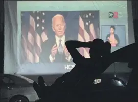  ?? Go Nakamura Getty I mages ?? BIDEN BACKERS watch the Democratic convention in August from a drive- in event in Houston. Even a close race in Texas may have huge political implicatio­ns.