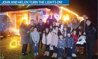  ??  ?? John and Helan O’Dowd switching on the Christmas lights at their house in Skreen with family and friends last Sunday. Every year the couple decorate their home with more than forty outside lights of different shapes and sizes.