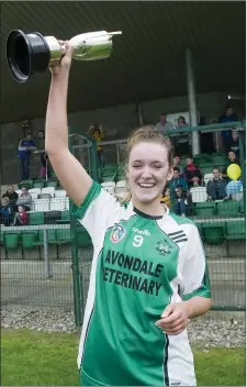  ??  ?? Avondale captain Katie Kennedy lifts the Intermedia­te camogie cup after their victory over Kiltegan.