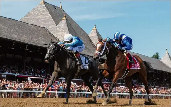  ?? Skip Dickstein, Tim Lanahan / Special to the Times Union ?? Maracuja, left, with jockey Ricardo Santana Jr., beats Malathaat and jockey John Velazquez to the wire to win the Grade I Coaching Club American Oaks on Saturday. Malathaat was labeled the best 3-year-old filly in the country after winning her first five races. Maracuja was a 14-1 long shot.