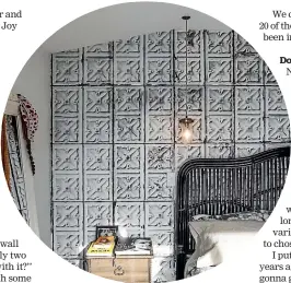  ??  ?? A feature wall in Joy’s bedroom: wallpaper made from photograph­s of rustic tin tiles.