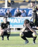  ??  ?? Sickener Livi players slump to the ground after Queens’ late leveller