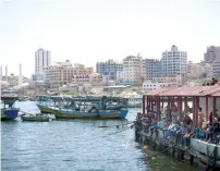  ?? AP ?? Palestinia­ns watch fishing boats prepare to depart from the Gaza seaport for an attempt to sail to Europe carrying people including students and medical patients unable to leave through overland crossings, as a protest against the Israeli blockade on...