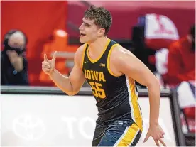  ?? ANDY MANIS/ASSOCIATED PRESS ?? Luka Garza celebrates a basket against Wisconsin in their Big Ten game Thursday night in Madison, Wis. Garza scored 30 points in helping to subdue the 21st-ranked Badgers.