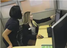  ?? Lea Suzuki / The Chronicle ?? Tax profession­als Fransiska Kane (left) and Nathellyn Olano discuss a client’s case at a San Francisco H&amp;R Block office.