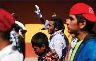  ?? AP/REBECCA BLACKWELL ?? Central American migrants march Thursday to a United Nations human-rights office in Mexico City to make their case for buses to carry them to the U.S. border.