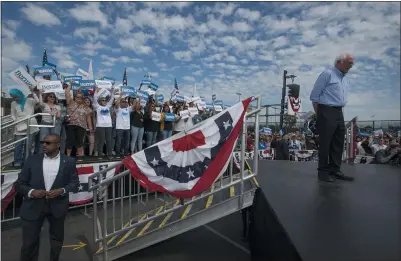  ?? DAMIAN DOVARGANES — THE ASSOCIATED PRESS ?? Democratic presidenti­al candidate Sen. Bernie Sanders, I-Vt., right, pauses as he speaks at a campaign event at Valley High School in Southern California on Friday.