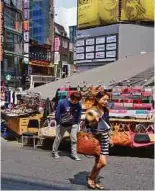  ?? PICTURES BY DAVID BOWDEN ?? Lively shopping streets in Seoul.