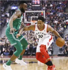  ??  ?? DeMar DeRozan (right) dribbles the ball as Boston Celtics guard Jaylen Brown defends during the first half at the Air Canada Centre. — USA TODAY Sports photo