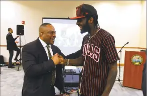  ?? Christian Abraham / Hearst Connecticu­t Media file photo ?? Harold Dimbo, left, a project manager with Project Longevity, speaks with parolee Joe Grits at the Margaret E. Morton Government Center Bridgeport in April.