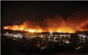  ?? NOAH BERGER — THE ASSOCIATED PRESS FILE ?? Smoke from the Maria Fire billows above Santa Paula.
The nation’s largest utility says its distributi­on lines have sparked no damaging wildfires since it began repeatedly shutting off power to hundreds of thousands of Northern California customers this fall. But Pacific Gas & Electric is not ruling out that failed transmissi­on equipment may have started a fire north of San Francisco that damaged or destroyed more than 400structu­res.