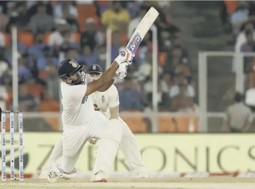  ??  ?? 0 India’s Rohit Sharma hits a boundary during day two of the third Test in Ahmedabad as the hosts stormed to a 10-wicket victory