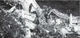  ??  ?? Rescue crew work in the wreckage from a plane that crashed into a Colombian jungle while carrying Brazilian soccer team Chapecoens­e near Medellin, Colombia, yesterday