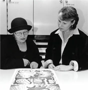  ??  ?? Darlene Coward Wight (right) examines artwork with famed printmaker Germaine Arnaktauyo­k at the Winnipeg Art Gallery, 1997