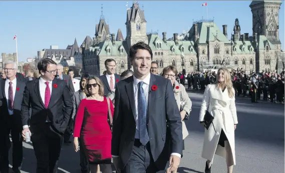  ?? JUSTIN TANG/THE CANADIAN PRESS ?? Prime Minister Justin Trudeau and his newly sworn-in cabinet ministers arrive on Parliament Hill in November 2015. The prime minister has, for the most part, kept most of his cabinet intact, and as he approaches the three-quarters point of his mandate,...