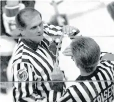  ?? THE CANADIAN PRESS/FILES ?? NHL officials including Kerry Fraser, right, measure the stick of L.A. Kings defenceman Marty McSorley during the final minutes of Game 2 in the 1993 Stanley Cup finals in Montreal. McSorley was assessed a two minute penalty for using an illegal stick.