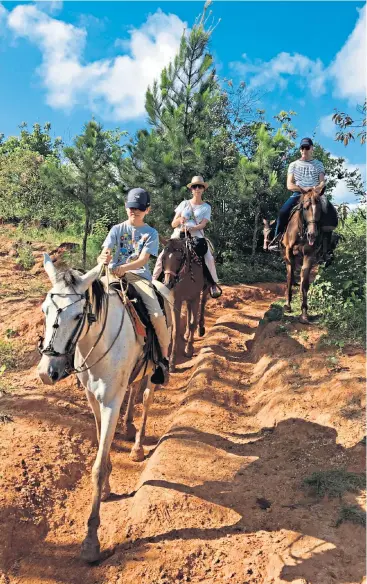  ??  ?? Horseplay: Kate’s 14-year-old son Freddie leads the way as guide Alexis keeps a close watch on the intrepid trainee riders