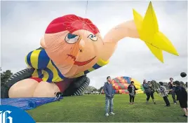  ??  ?? Giant shapes slowly rise as balloonist­s prepare their craft for the morning journey.