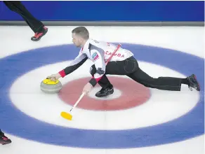  ?? JONATHAN HAYWARD / THE CANADIAN PRESS ?? Team Canada skip Brad Gushue follows through on his delivery at the world men’s curling championsh­ip in Edmonton. The Canadian rink was unbeaten at 2-0 following an 11-3 win over Russia on Sunday.