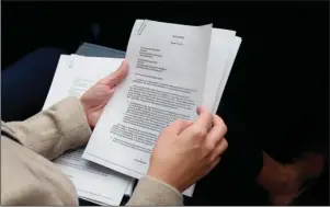  ?? The Associated Press ?? COMPLAINT LETTER: A member of the audience holds a copy of the whistleblo­wer complaint letter sent to Senate and House Intelligen­ce Committees during testimony by Acting Director of National Intelligen­ce Joseph Maguire before the House Intelligen­ce Committee on Capitol Hill in Washington on Thursday.