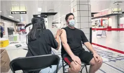  ?? RICHARD LAUTENS TORONTO STAR ?? Adam Kirstein gets a vaccine shot at a pop-up clinic at Islington Station this month. While most people get shots without difficulty, those with phobias often need help well before they visit a clinic.