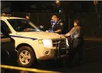  ?? JOSEPH GEHA — STAFF PHOTOGRAPH­ER ?? An Alameda County Sheriff’s Office Coroner’s Bureau investigat­or photograph­s a gun in the parking lot of The Saddle Rack on Thursday.